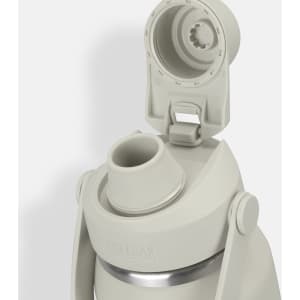 A drink bottle in light grey with a screw-on lid and spout, featuring a logo on the body.