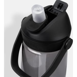 A drink bottle made of grey plastic with a black cap and handle, featuring a flip straw and a logo.
