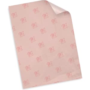 A piece of pale pink tissue paper featuring a repeated logo pattern. The paper is slightly curled at one corner.