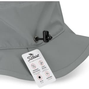 A grey bucket hat featuring a branded tag and an adjustable toggle on the brim.