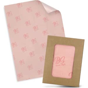 Tissue paper in pale pink featuring a logo, packaged with a matching envelope in a brown cardboard frame.