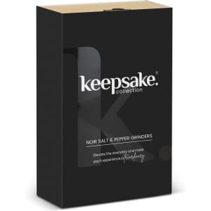 A black box containing Keepsake Noir salt and pepper grinders, featuring a sleek logo and elegant design.