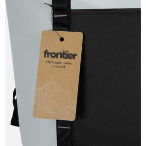 A grey and black cooler toting pack featuring a tag with a mountain design and a logo.