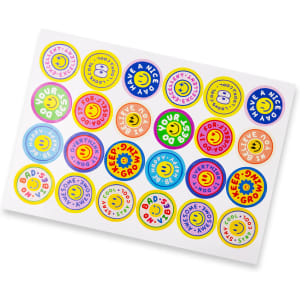 A sheet of glossy stickers featuring colourful 44mm circles with various designs and a logo.