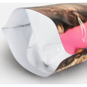 A foil stand-up pouch in vibrant pink and brown patterns, featuring a smooth, glossy finish and a hidden logo.