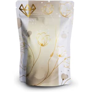 A small foil stand-up pouch in white and gold with a floral design and a logo at the top.