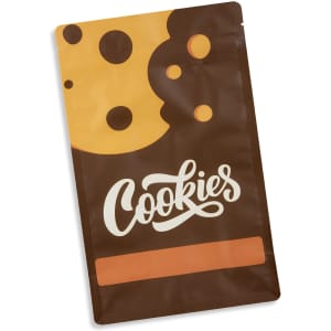 A small foil flat bottom pouch in brown with yellow and black cookie designs, featuring a logo.