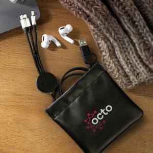 A black tech pouch with a logo, containing charging cables and white earbuds, placed on a wooden surface.