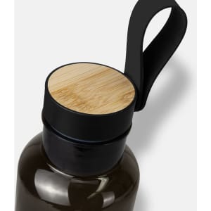 A drink bottle in dark green with a black lid and a bamboo top, featuring a looped handle.