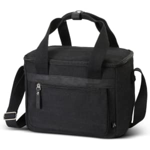 A black canvas cooler bag with a zippered main compartment, front pocket, and adjustable shoulder strap.