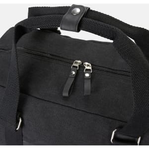 A black canvas duffle bag featuring sturdy handles and a zippered compartment. It has a branding logo.
