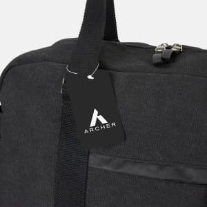 A black canvas duffle bag with a shoulder strap and a tag featuring a logo.