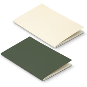 A green and cream soft cover notebook made from recycled paper, featuring a simple design and branding.