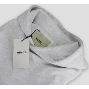 A grey hoodie with a hood and tags, featuring a logo on the tags.