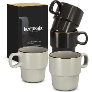 A set of two stackable coffee cups in grey and black, packaged in a box with a logo.