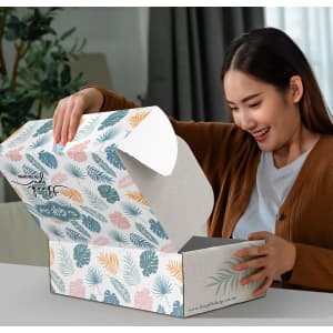 A rectangular die cut box with a locking lid, featuring a floral pattern in greens, blues, and peach tones.
