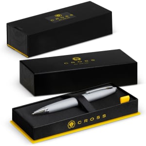 A sleek grey Cross Calais ballpoint pen in a black and yellow presentation box with a logo.
