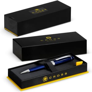A Cross Bailey ballpoint pen in a black and gold box, featuring a navy blue pen secured with a black strap.