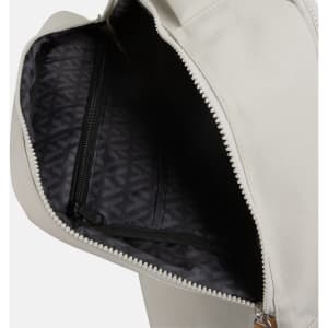 An open grey backpack featuring a dark patterned interior and a zippered pocket.