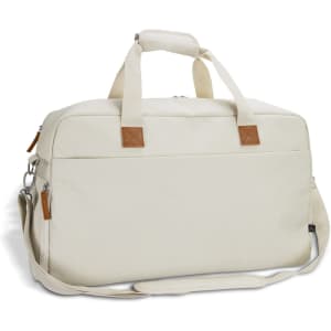A cream-coloured duffle bag with a detachable shoulder strap and leather accents, featuring top handles and zip closure.