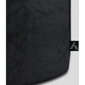 A black duffle bag featuring a textured surface and a logo on the side.