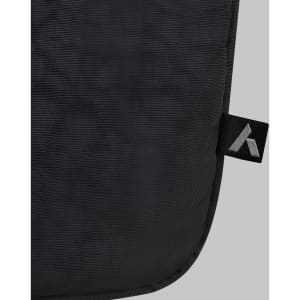 A black laptop bag features a smooth texture and a small branding tag in the corner.