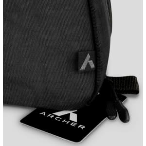 A black toiletry bag featuring a logo, with a smooth fabric texture and a zippered opening.