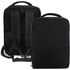 A black travel backpack with padded shoulder straps and a top handle, featuring an exterior logo.