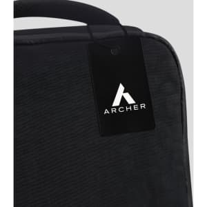 A black travel backpack with a tag featuring a logo. The material looks durable and stylish.