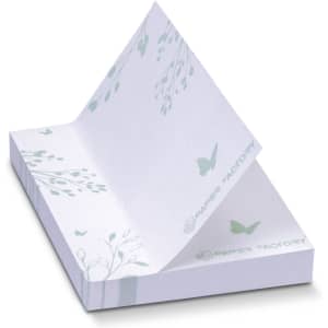 A stack of white recycled sticky pads, featuring delicate leaf and butterfly designs in soft green, with a branding logo.