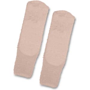 Fluffy grip socks in a soft beige colour, featuring a textured surface for added grip. Includes a logo.