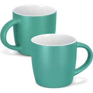 A coffee mug in teal with a contrasting white interior, featuring a handle and a smooth matte finish.