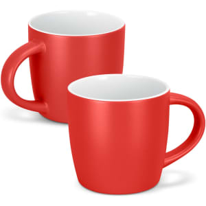A drinkware set featuring two red mocha coffee mugs with contrasting white interiors and a curved handle.