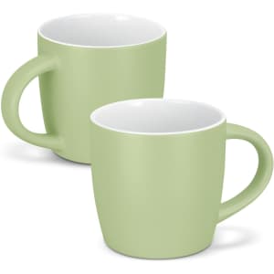 A green coffee mug with a smooth finish and a comfortable handle. It features a contrasting white interior.