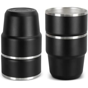 A set of two stackable cups in matte black with a silver band. Each cup has a sleek, modern design.