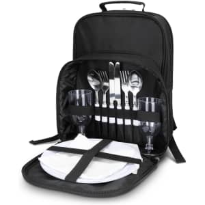 A black picnic backpack with cutlery, wine glasses, napkins, and plates neatly arranged inside.