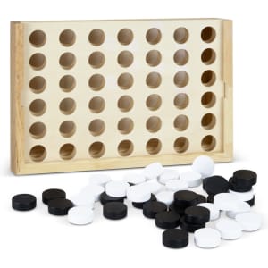 A wooden four-in-a-row game set featuring a light wood frame, with black and white game discs scattered nearby.
