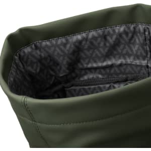 A soft-touch, olive green flap backpack with a patterned black interior and a zippered pocket inside.