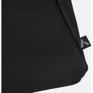 A black soft-touch duffle bag featuring a small branded tag on the side.