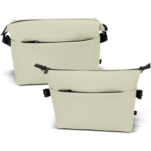A soft-touch toiletry bag in cream, featuring multiple compartments and a strap, with a logo on the front.