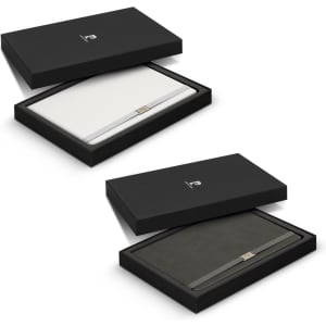 A notebook gift set in white and black, presented in a sleek black box with a logo.
