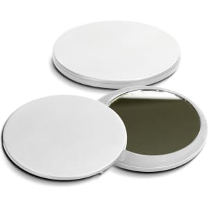 A compact mirror in white, featuring a circular design with a reflective interior and a smooth, flat exterior.