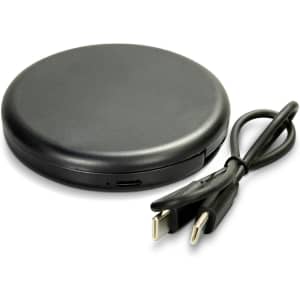A compact black charging pad with a USB cable. The design is sleek and round.