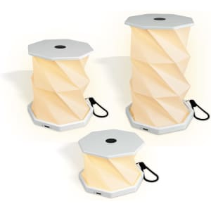 A foldable lantern in cream with a textured, hexagonal design, featuring a white base and a USB port.