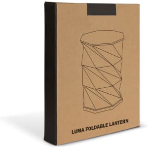 A beige box featuring an illustration of a foldable lantern with a geometric design. The box has a logo.
