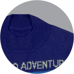 A knitted jumper in navy blue with a high neckline and ribbed collar, featuring a design on the front.