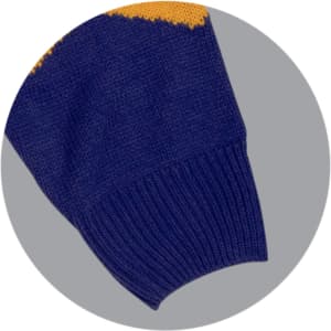 A knitted jumper featuring a navy blue body with yellow design elements on the sleeves and a ribbed cuff.