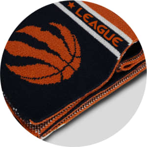 A knitted scarf in navy blue and orange, featuring a basketball design and an emblem. It has a logo on it.