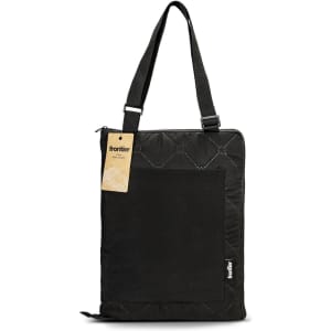 A black quilted picnic blanket with a shoulder strap and a large pocket, featuring a logo on the side.