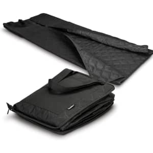 A black picnic blanket laid out flat, featuring a quilted texture, with a folded version showcasing a carrying handle.